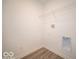 Bright laundry room with wooden floor, washer hookups, and a wire shelf above at 3201 W Keepsake Ln, Monrovia, IN 46157
