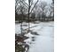 Snowy backyard with patchy grass and a chain link fence at 3357 N Drexel Ave, Indianapolis, IN 46218