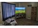 A cozy carpeted room with a TV, media center and dark curtains at 3951 N Pasadena St, Indianapolis, IN 46226