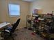A bedroom features a shoe rack filled with shoes and purses, next to a desk and office chair at 3951 N Pasadena St, Indianapolis, IN 46226