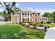 Brick two-story house with a balcony, landscaping, and a walkway at 4506 Sylvan Rd, Indianapolis, IN 46228