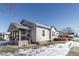 Gray house with a wooden deck and snowy yard. Beautiful curb appeal at 4759 Ohio St, Clayton, IN 46118