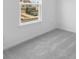 Carpeted bedroom with a window offering a view of the neighborhood at 4767 E Shadowbrook Dr, Camby, IN 46113