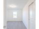 Bright bedroom with a window and gray carpeting at 4767 E Shadowbrook Dr, Camby, IN 46113