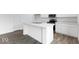 Open kitchen with granite countertops, white cabinetry, stainless steel appliances, and a kitchen island at 4767 E Shadowbrook Dr, Camby, IN 46113