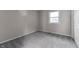 Bright bedroom with grey carpet and neutral walls at 5102 Guion Rd, Indianapolis, IN 46254