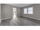 Dining room or living area with grey vinyl flooring and kitchen view at 5102 Guion Rd, Indianapolis, IN 46254