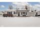 White ranch home with covered porch and snow covered yard at 5150 Atherton N Dr, Indianapolis, IN 46219