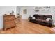 Living room with hardwood floors, brown sofa, and antique secretary at 5150 Atherton N Dr, Indianapolis, IN 46219