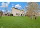 Spacious backyard features a well-maintained lawn, mature trees, and a view of the home's rear exterior at 5230 Berkshire South Blvd, Greenwood, IN 46142