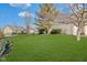 A well-maintained backyard featuring a lush lawn and mature trees, perfect for outdoor activities at 5230 Berkshire South Blvd, Greenwood, IN 46142