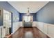 Formal dining room with dark hardwood floors and a charming chandelier at 5230 Berkshire South Blvd, Greenwood, IN 46142