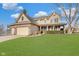 Charming two-story home featuring a brick-accented facade, attached garage, and a well-manicured lawn under a bright, cloudy sky at 5230 Berkshire South Blvd, Greenwood, IN 46142