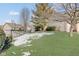 Side yard with basketball hoop and partially snow-covered lawn at 5230 Berkshire South Blvd, Greenwood, IN 46142