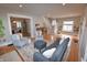 A cozy living room featuring lots of seating, hardwood floors, and staircase at 5460 E University Ave, Indianapolis, IN 46219