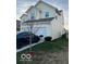 Side view of a two-story house with attached garage and driveway at 6628 Heben Ct, Indianapolis, IN 46113