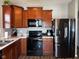 Modern kitchen with stainless steel appliances and wood cabinets at 6628 Heben Ct, Indianapolis, IN 46113