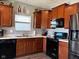 Modern kitchen with stainless steel appliances and wood cabinets at 6628 Heben Ct, Indianapolis, IN 46113