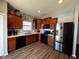 Modern kitchen with stainless steel appliances and wood cabinets at 6628 Heben Ct, Indianapolis, IN 46113