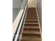 Beige carpeted staircase with white railing at 6628 Heben Ct, Indianapolis, IN 46113