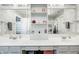 Bright bathroom with a double sink vanity featuring large mirrors and built-in shelving at 7129 Dublin Ln, Indianapolis, IN 46239