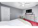 Bedroom with neutral walls and carpet featuring a ceiling fan and a bed with a red rug at 7129 Dublin Ln, Indianapolis, IN 46239