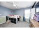 Bedroom featuring a ceiling fan, a trundle bed, and two-tone walls at 7129 Dublin Ln, Indianapolis, IN 46239