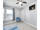 Cozy bedroom with large windows, a comfortable chair, and neutral carpet at 7129 Dublin Ln, Indianapolis, IN 46239