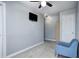 Bedroom features a ceiling fan, neutral flooring, and a comfortable chair at 7129 Dublin Ln, Indianapolis, IN 46239