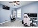 Bedroom featuring a ceiling fan and a hanging swing chair with a nearby workstation at 7129 Dublin Ln, Indianapolis, IN 46239