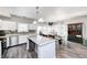 Bright kitchen features an island with a white beadboard, stainless appliances, and hardwood floors at 7129 Dublin Ln, Indianapolis, IN 46239