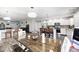 Open kitchen with stainless steel appliances, white cabinetry, island seating, and adjacent dining area at 7129 Dublin Ln, Indianapolis, IN 46239