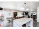 Open kitchen flows into living area featuring a rustic island, wood floors, and neutral decor at 7129 Dublin Ln, Indianapolis, IN 46239