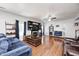 Bright living room with hardwood floors, fireplace, ceiling fan, and comfortable seating at 7129 Dublin Ln, Indianapolis, IN 46239