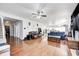 Open concept living room with hardwood flooring, large windows, and access to the kitchen at 7129 Dublin Ln, Indianapolis, IN 46239