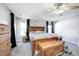 Spacious main bedroom with a ceiling fan, ample natural light, and wood furniture at 7129 Dublin Ln, Indianapolis, IN 46239