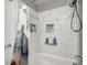 Tiled shower with built-in shelving, offering ample storage space for toiletries at 7129 Dublin Ln, Indianapolis, IN 46239