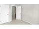 Empty bedroom with neutral walls, carpet, and access to a bathroom at 7620 Baywood S Dr, Indianapolis, IN 46236