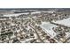 Aerial view of a snow-covered residential neighborhood with houses and a frozen pond at 7746 Cole Wood Blvd, Indianapolis, IN 46239