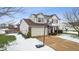 Two-story house with basketball hoop, attached garage, and snowy yard at 7746 Cole Wood Blvd, Indianapolis, IN 46239