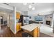 Kitchen with island, stainless steel appliances, and views into living room at 7746 Cole Wood Blvd, Indianapolis, IN 46239