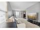 Living room with large windows, beige couch, and hardwood floors at 7746 Cole Wood Blvd, Indianapolis, IN 46239