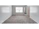 Spacious bedroom with gray carpeting and French doors at 7824 Rosebush Dr, Indianapolis, IN 46237