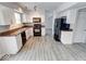 Kitchen with white cabinets, granite counters, and black appliances at 7824 Rosebush Dr, Indianapolis, IN 46237