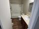 Bathroom featuring a tub-shower combo, single sink vanity, and neutral color scheme at 835 E Berwyn St, Indianapolis, IN 46203