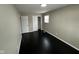Well-lit bedroom featuring dark hardwood floors and a closet at 835 E Berwyn St, Indianapolis, IN 46203