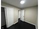 Bedroom with dark hardwood floors and access to hallway at 835 E Berwyn St, Indianapolis, IN 46203