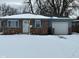 Brick ranch home with attached garage, snowy front yard at 835 E Berwyn St, Indianapolis, IN 46203