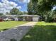 Charming single-story home with a brick facade, inviting front yard and a private driveway at 835 E Berwyn St, Indianapolis, IN 46203