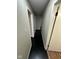 Long hallway with dark hardwood floors and neutral walls at 835 E Berwyn St, Indianapolis, IN 46203